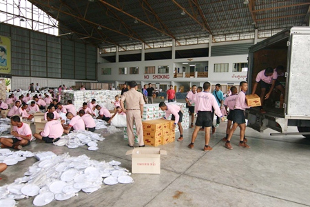 Seamen package and load supplies to send to flood victims in the south.